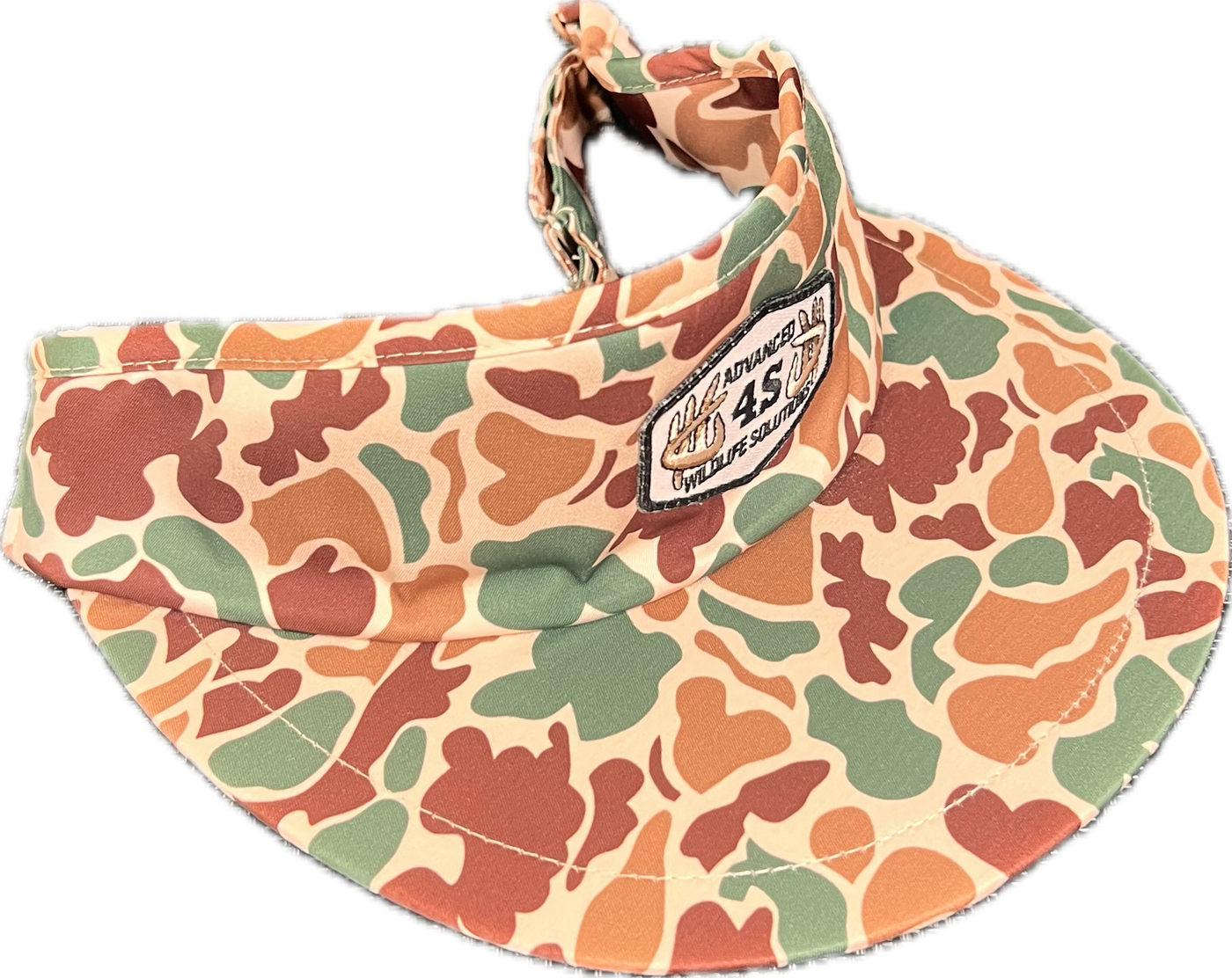 A camo print visor with an adjustable buckle in the back and a white hexagon patch on the front.
