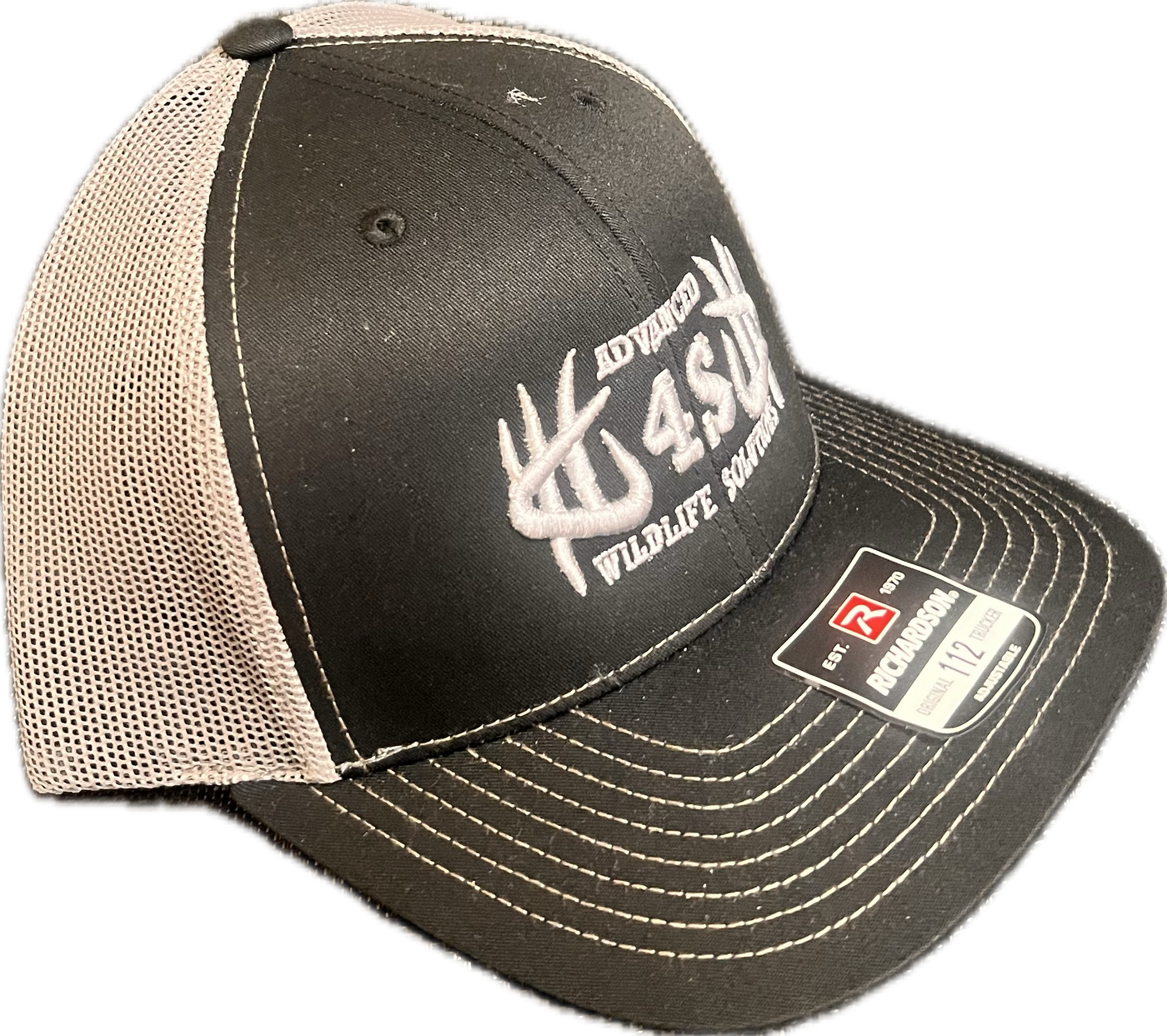 A black and white mesh hat with an embroidered logo on the front, a black bill, and white stitching.