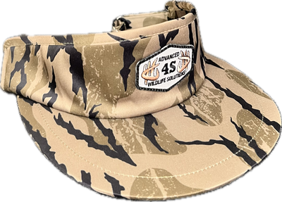 A camouflaged tall visor with a white hexagon patch and an adjustable buckle.